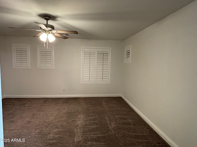 unfurnished room with ceiling fan and dark colored carpet