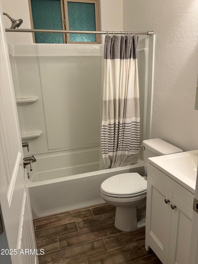 full bathroom with shower / bath combination with curtain, vanity, and toilet