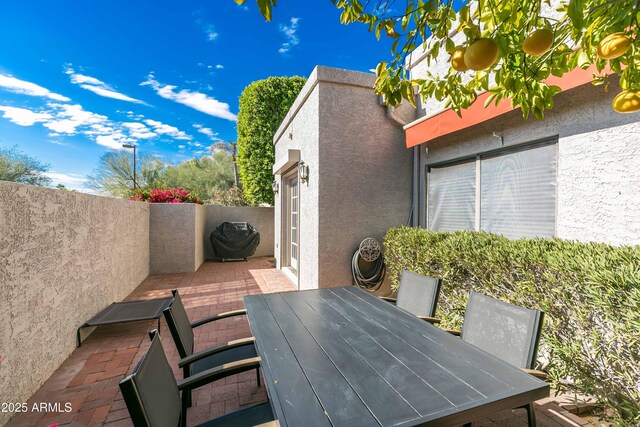 view of patio with a grill and outdoor dining area