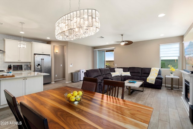 26242 N 122nd Ln, Peoria, AZ 85383 - dining room with recessed lighting, light wood-style floors, ceiling fan with notable chandelier, and baseboards
