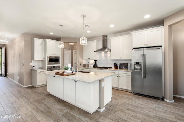 26242 N 122nd Ln, Peoria, AZ 85383 - kitchen featuring wall chimney exhaust hood, white cabinets, appliances with stainless steel finishes, a sink, and decorative backsplash