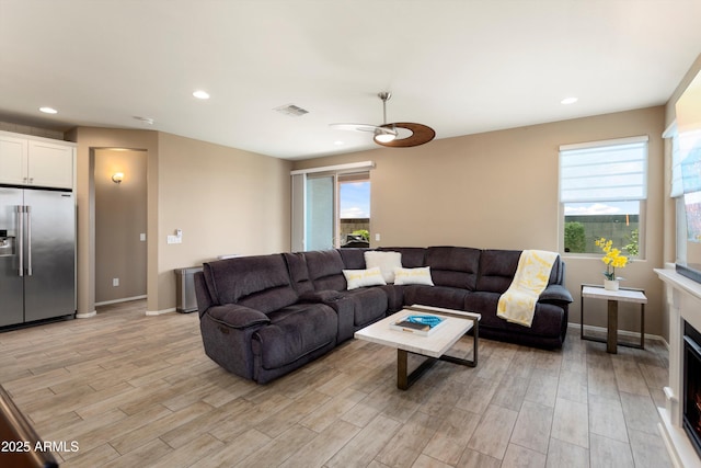26242 N 122nd Ln, Peoria, AZ 85383 - living area with visible vents, a ceiling fan, light wood-style floors, and a healthy amount of sunlight