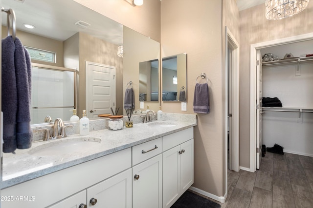 26242 N 122nd Ln, Peoria, AZ 85383 - bathroom with a stall shower, double vanity, a sink, and a spacious closet