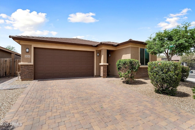 26242 N 122nd Ln, Peoria, AZ 85383 - prairie-style home with stucco siding, decorative driveway, fence, a tile roof, and a garage