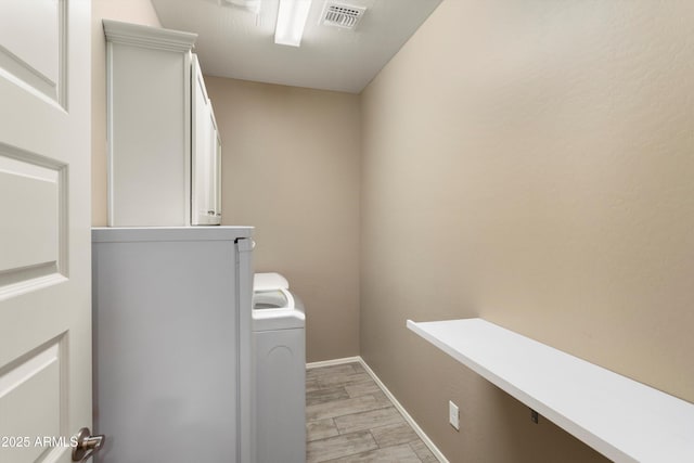 26242 N 122nd Ln, Peoria, AZ 85383 - clothes washing area featuring wood tiled floor, baseboards, visible vents, and washer / dryer