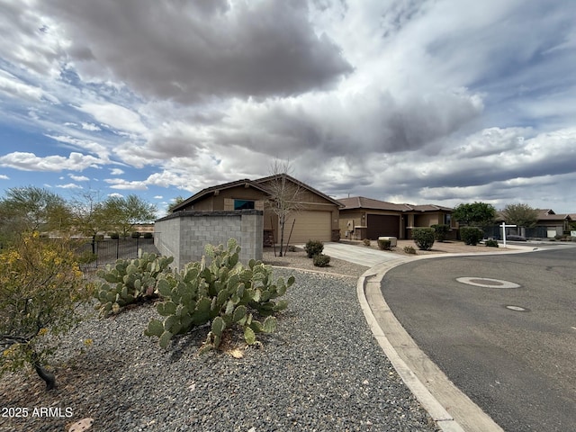 26242 N 122nd Ln, Peoria, AZ 85383 - view of front of property with an attached garage, concrete driveway, concrete block siding, and fence