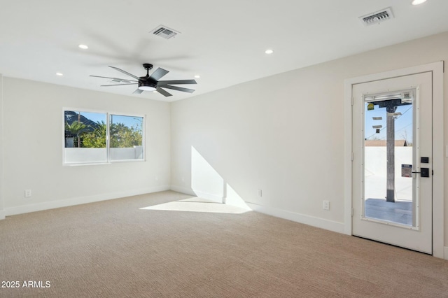 empty room with ceiling fan and light colored carpet