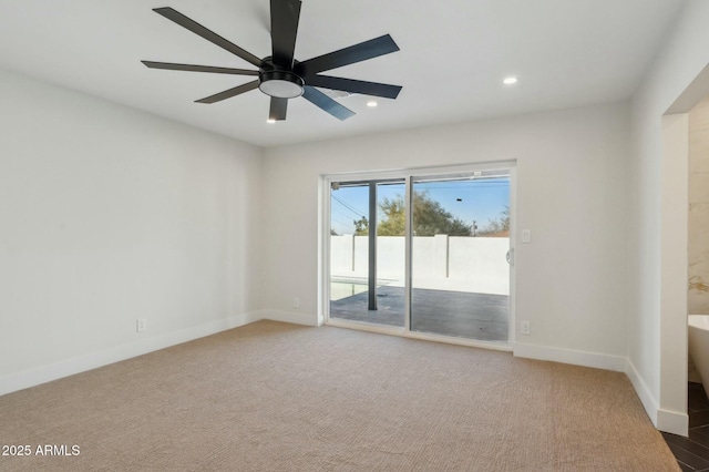 carpeted spare room with ceiling fan