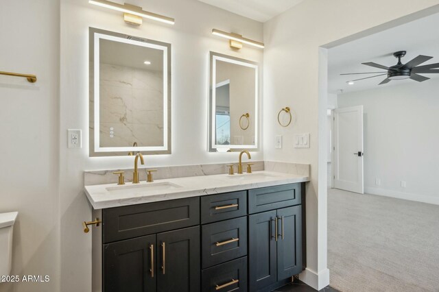 bathroom with ceiling fan and vanity