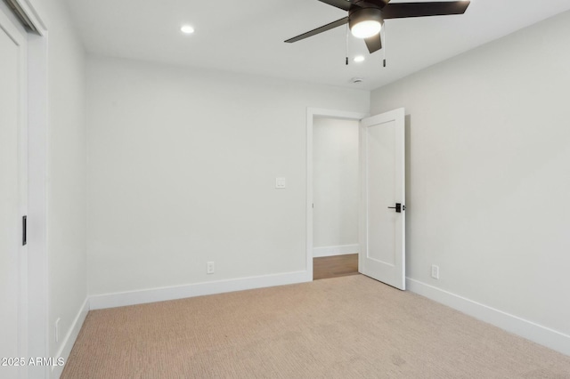 unfurnished bedroom with ceiling fan and light carpet