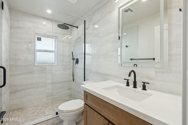 bathroom with a shower with door, vanity, tasteful backsplash, and toilet