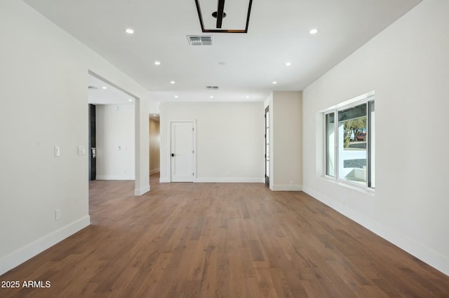 empty room with hardwood / wood-style floors