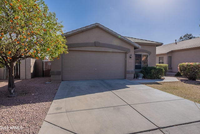 ranch-style house with concrete driveway, a tile roof, an attached garage, and stucco siding