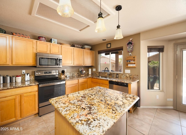 12933 W Monterey Way, Avondale, AZ 85392 - kitchen featuring stainless steel appliances, light tile patterned floors, light stone countertops, decorative light fixtures, and light brown cabinetry