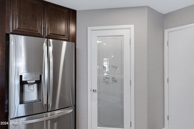 kitchen with dark brown cabinetry and stainless steel fridge