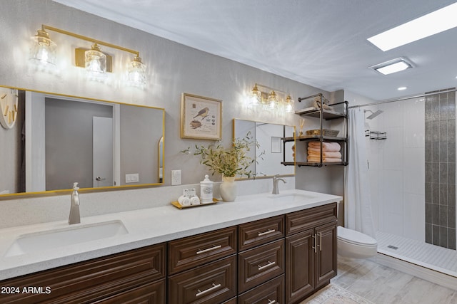 bathroom featuring toilet, curtained shower, and vanity