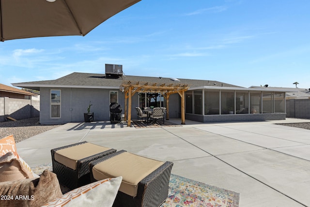 back of property with a patio, central air condition unit, a sunroom, and a pergola