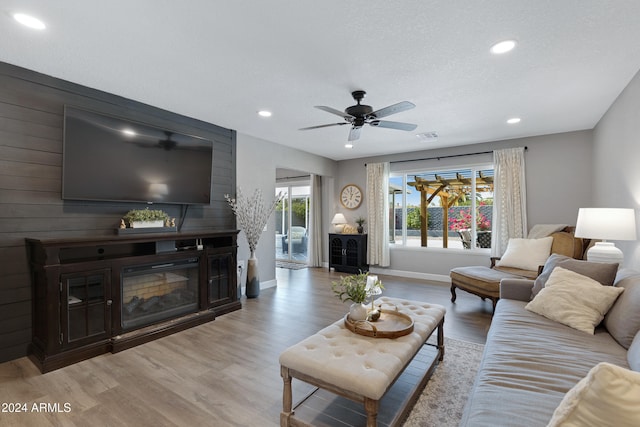 living room featuring light wood-type flooring and ceiling fan