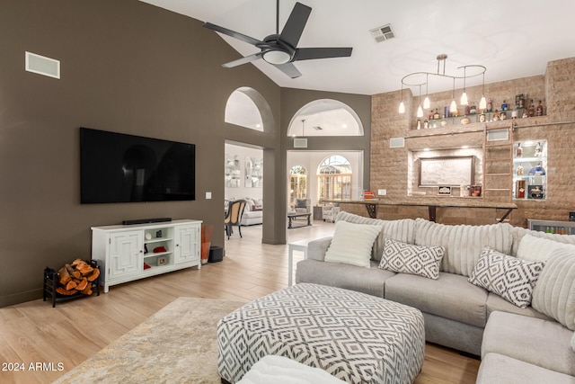 living room with high vaulted ceiling, wood-type flooring, and ceiling fan