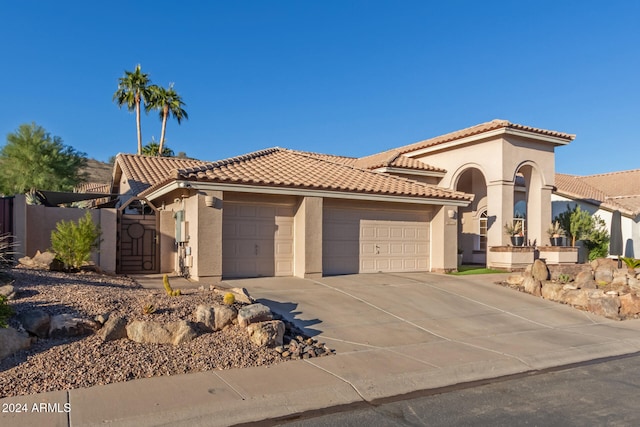 mediterranean / spanish-style house with a garage