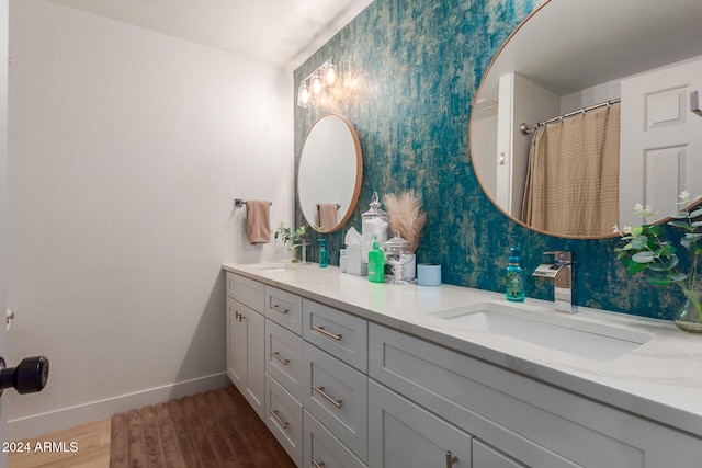 bathroom with vanity and hardwood / wood-style flooring