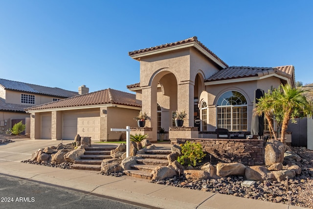 mediterranean / spanish-style house featuring a garage