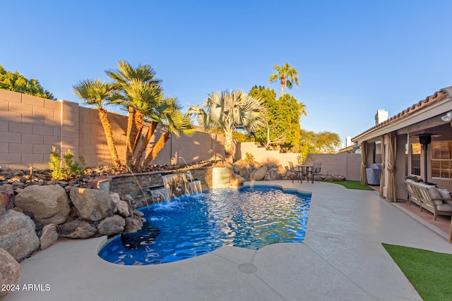 view of pool with a patio and pool water feature