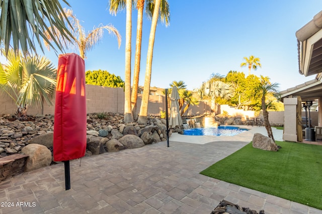 view of patio / terrace featuring pool water feature and a fenced in pool