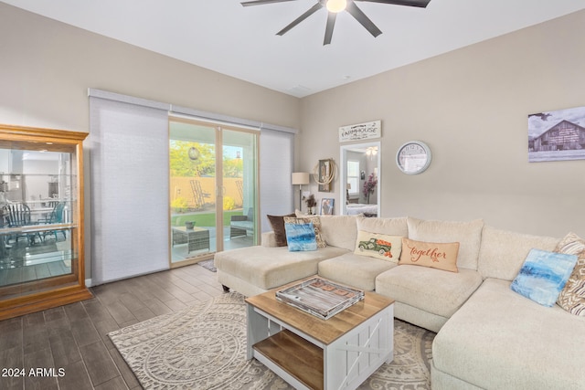 living room featuring dark wood-type flooring and ceiling fan