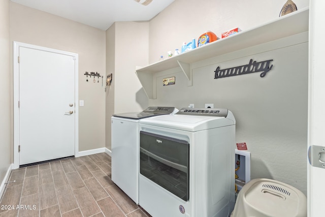 laundry room featuring light hardwood / wood-style flooring and washing machine and dryer