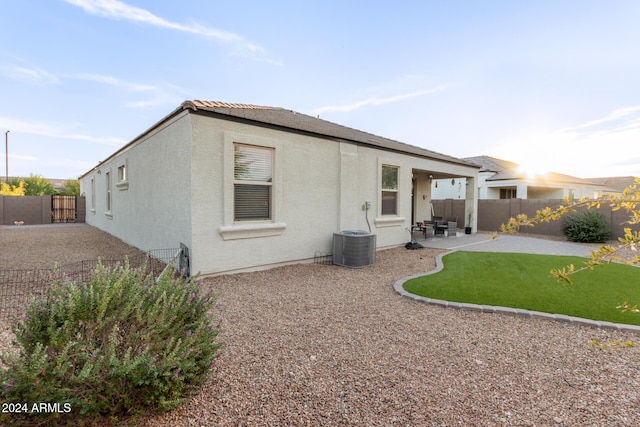 back of property featuring a patio and central air condition unit