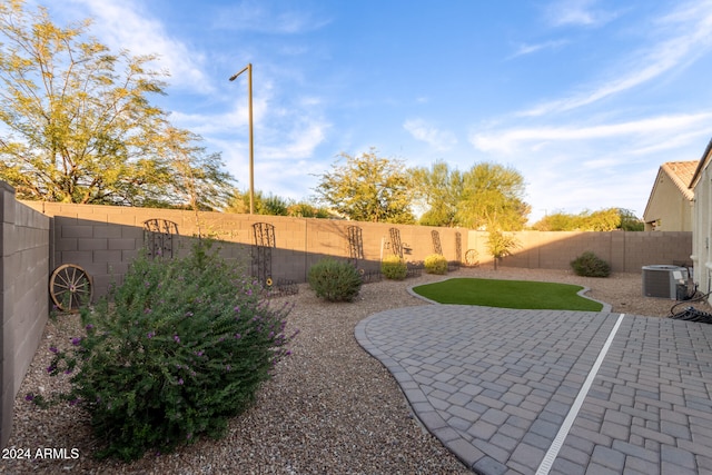 view of yard featuring cooling unit and a patio area