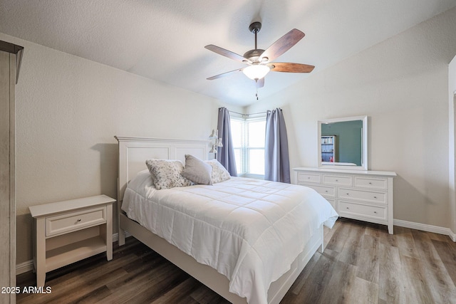 bedroom featuring ceiling fan, wood-type flooring, and vaulted ceiling