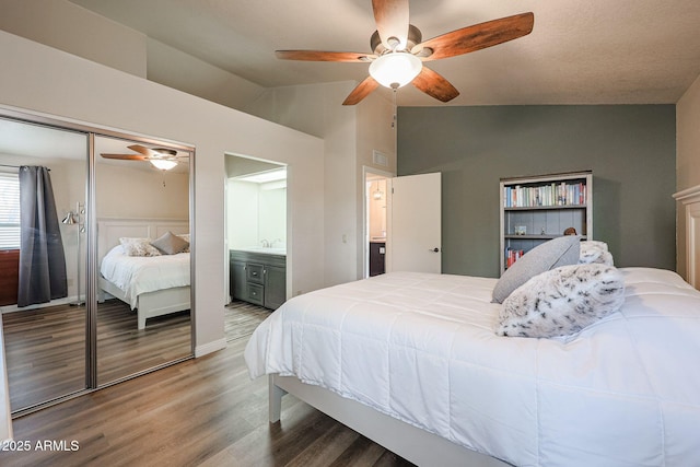 bedroom featuring lofted ceiling, hardwood / wood-style flooring, a closet, and ceiling fan