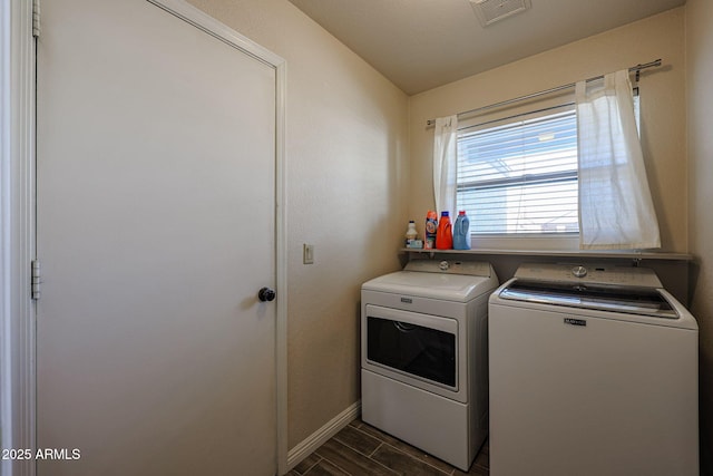 clothes washing area with separate washer and dryer