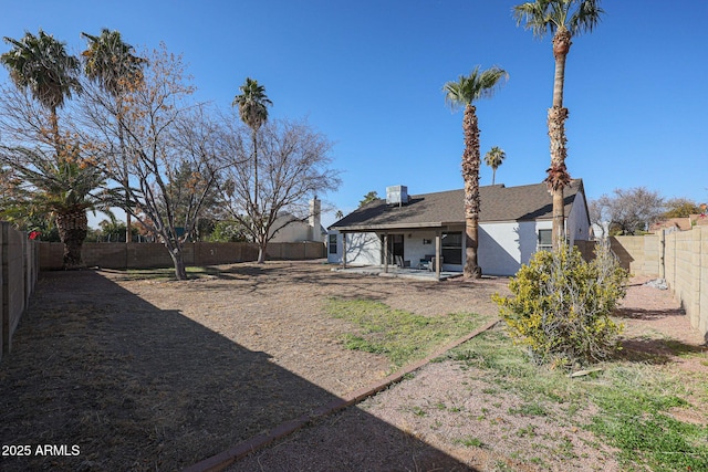 view of yard with central AC and a patio