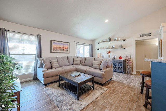 living room with vaulted ceiling and light hardwood / wood-style floors