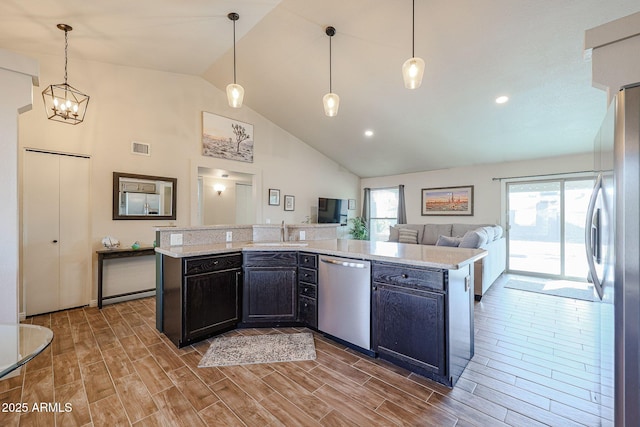 kitchen with stainless steel appliances, a healthy amount of sunlight, hanging light fixtures, and sink