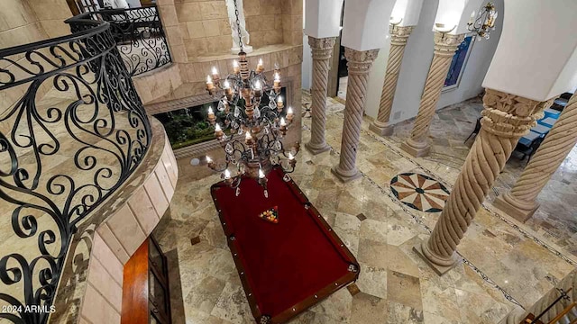 room details featuring decorative columns and a chandelier