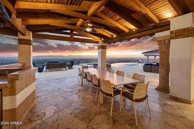 patio terrace at dusk with a gazebo and ceiling fan