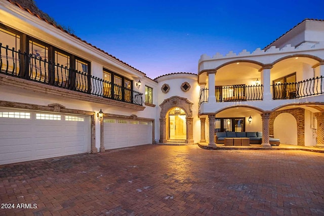 mediterranean / spanish-style home with a balcony and a garage