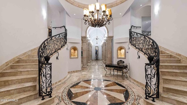 foyer entrance featuring an inviting chandelier and a high ceiling