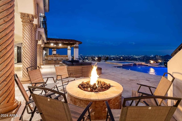 patio at night with a fire pit