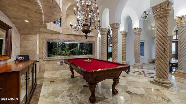 game room featuring a towering ceiling, pool table, and ornate columns