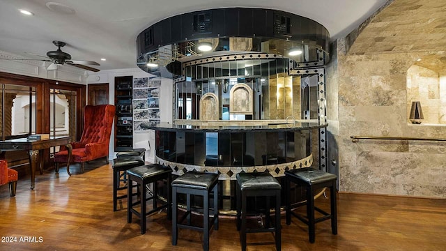 bar featuring ornamental molding, ceiling fan, and hardwood / wood-style floors