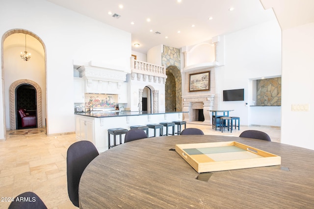 dining area with a towering ceiling