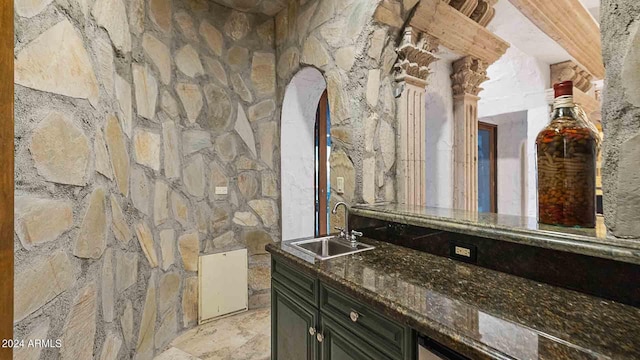 bathroom featuring ornate columns and sink