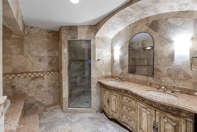 bathroom with vanity, tile walls, and an enclosed shower