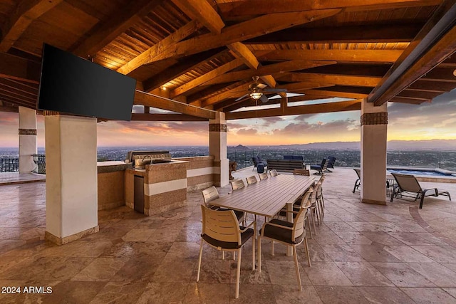 view of patio / terrace with ceiling fan and an outdoor kitchen