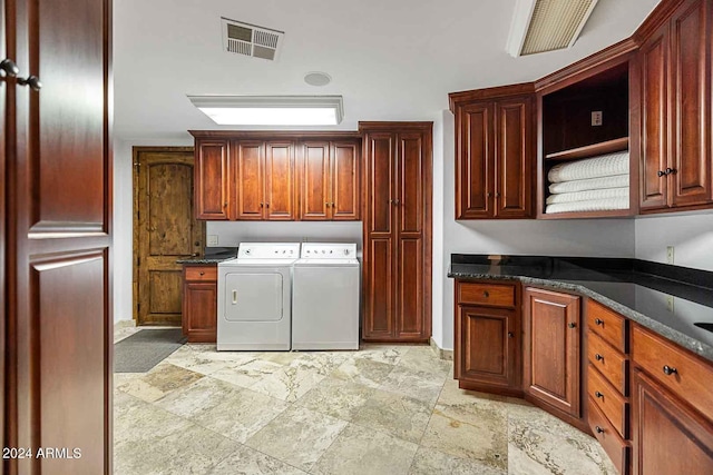 laundry room with cabinets and washer and dryer